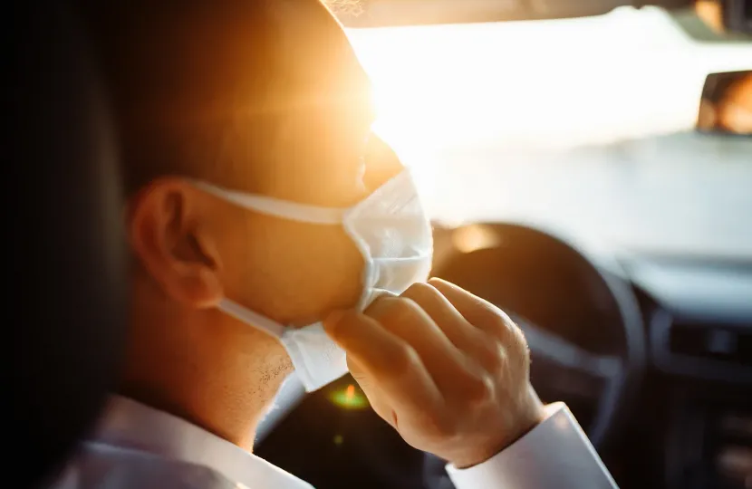 Masked person in car