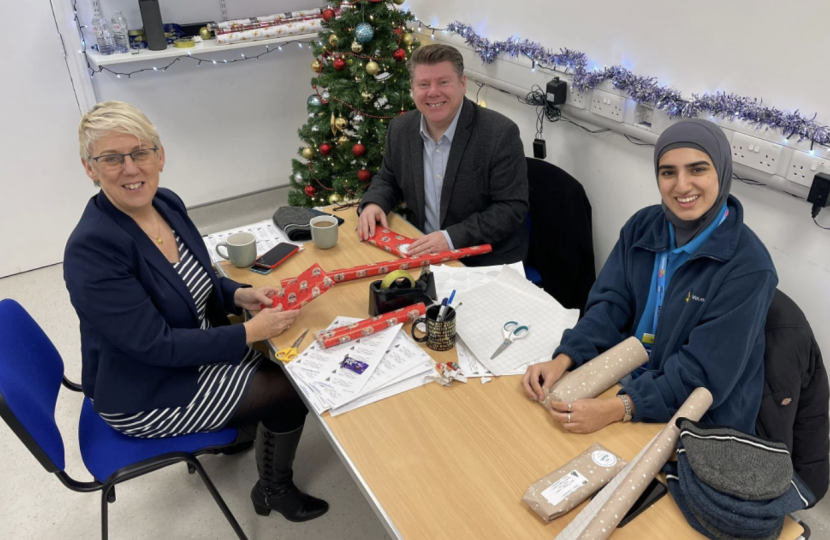 Dean Russell helps with Christmas wrapping