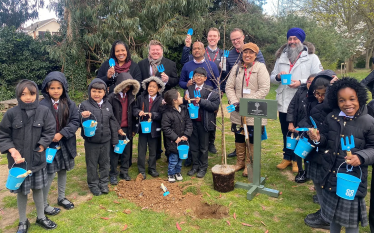 Dean Russell planting apple trees at Stanborough Primary School